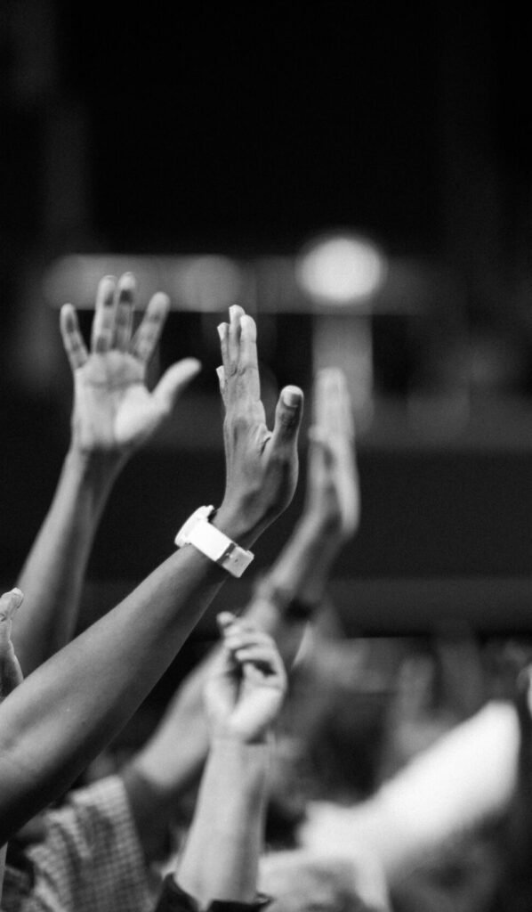 Grayscale Photography Of Hands Waving